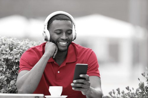 A man in headphones looking at his phone